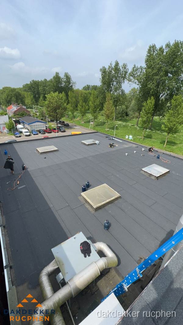Dakdekker aan het werk op groot plat dak met bitumen in Rucphen Dakdekker aan het werk op groot plat dak met bitumen in Rucphen
